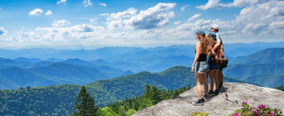 People overlooking mountains