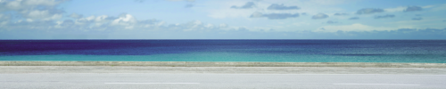 Horizontal road with ocean in the background.