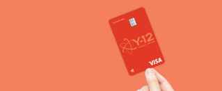 Hand holding a Visa Signature Rewards Credit Card.