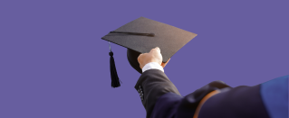 Hand holding a graduation cap.