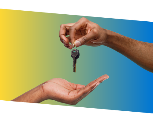 Hand holding keychain with keys with a yellow to blue gradient background.