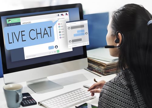 woman with headset working on computer